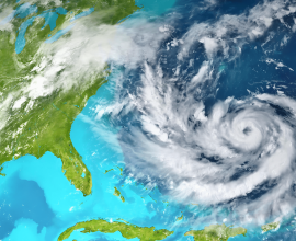 A satellite image of Cyclone Remal swirling over the Bay of Bengal, with thick cloud bands and a well-defined eye.