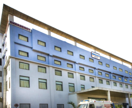 Exterior view of Shalby hospital building with an emergency entrance and ambulance, relevant to Shalby Q1 results.