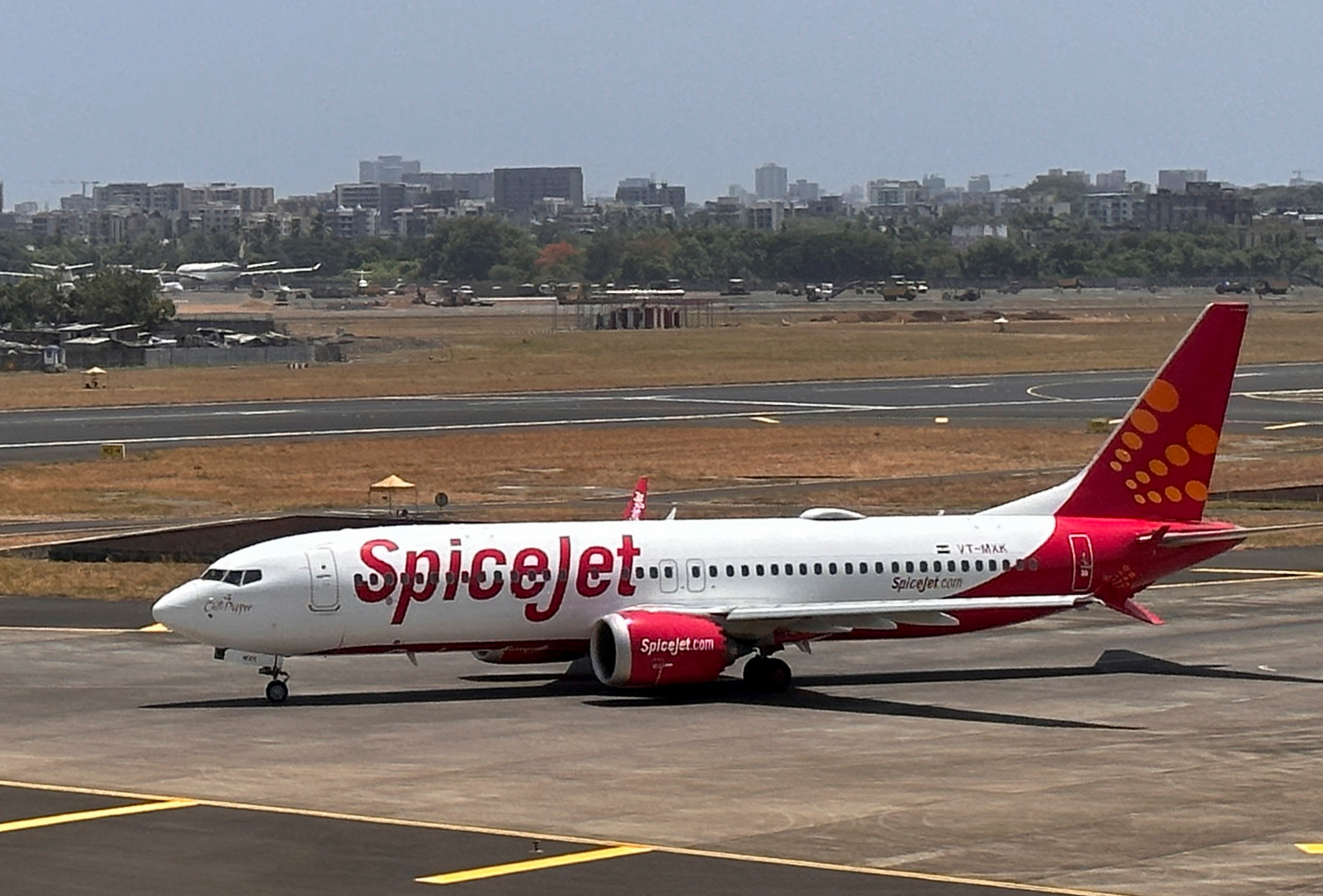 SpiceJet passenger airplane on a runway, with the SpiceJet logo prominent on the tail fin.