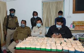 Police officers and officials displaying seized narcotics, highlighting the issue of Tripura drug abuse.