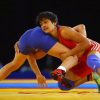 Vinesh Phogat grappling with an opponent during a wrestling match. Phogat was later disqualified from the competition.