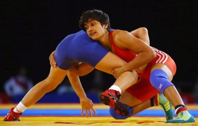 Vinesh Phogat grappling with an opponent during a wrestling match. Phogat was later disqualified from the competition.