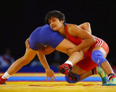 Vinesh Phogat grappling with an opponent during a wrestling match. Phogat was later disqualified from the competition.