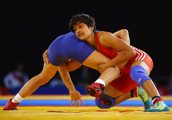 Vinesh Phogat grappling with an opponent during a wrestling match. Phogat was later disqualified from the competition.